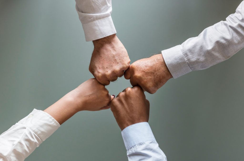 Fistbumps with people in shirts